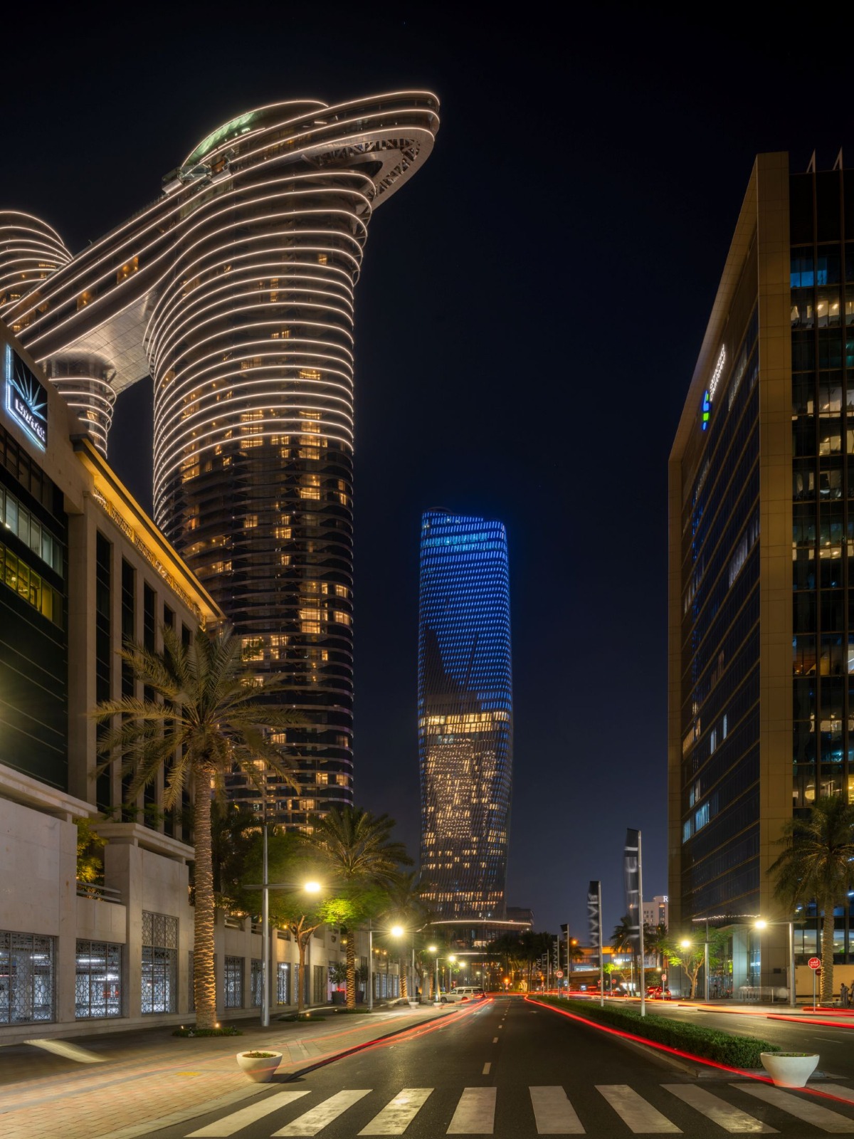 Upward wide-angle view of Wasl Tower emphasising the twisting ceramic facade
