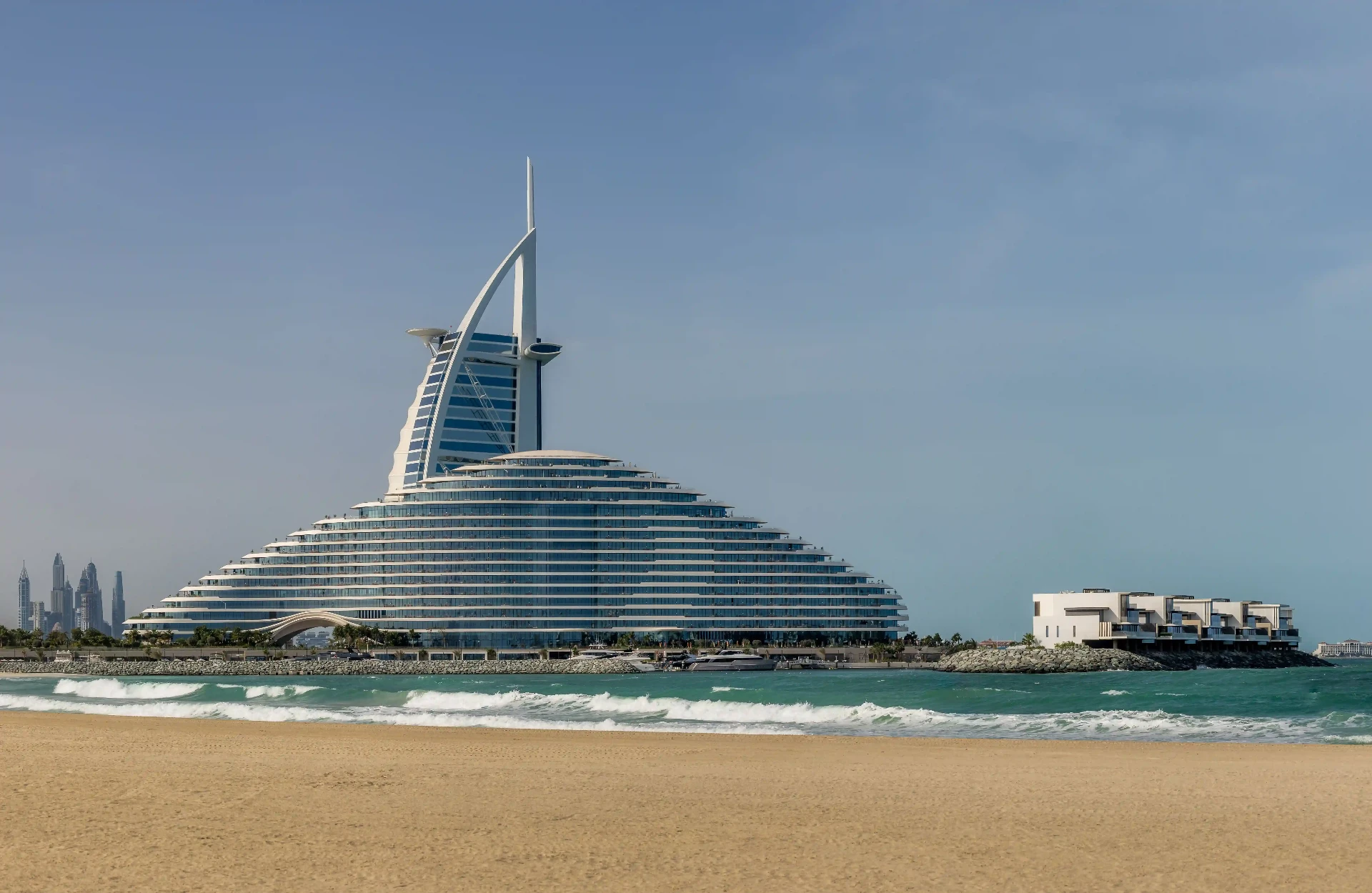 Iconic UAE hotel exterior photographed against a clear coastal sky
