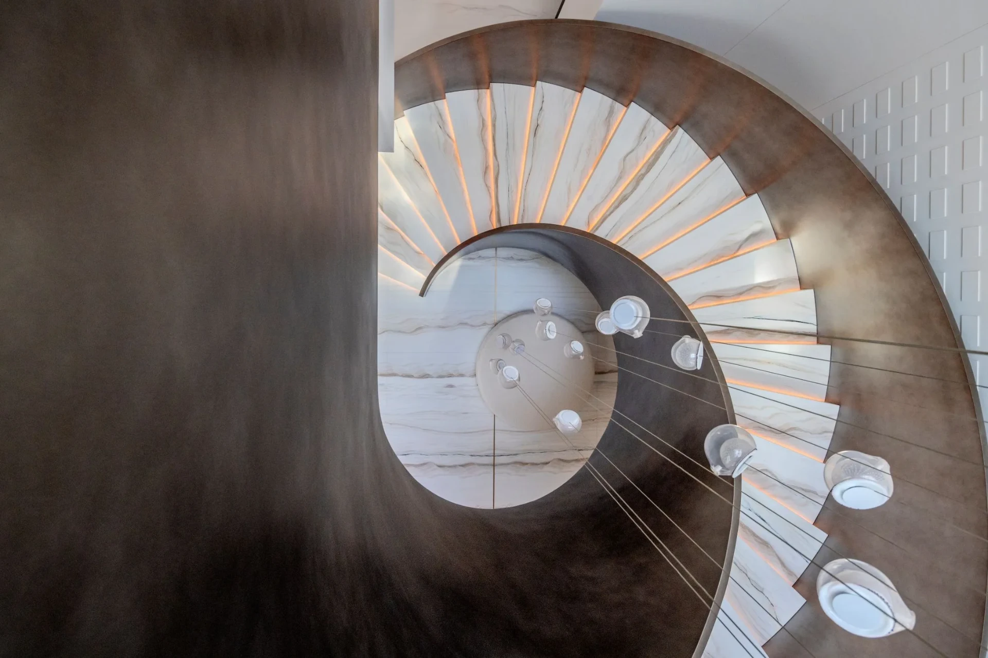 Spiral staircase photographed from below as a geometric abstraction