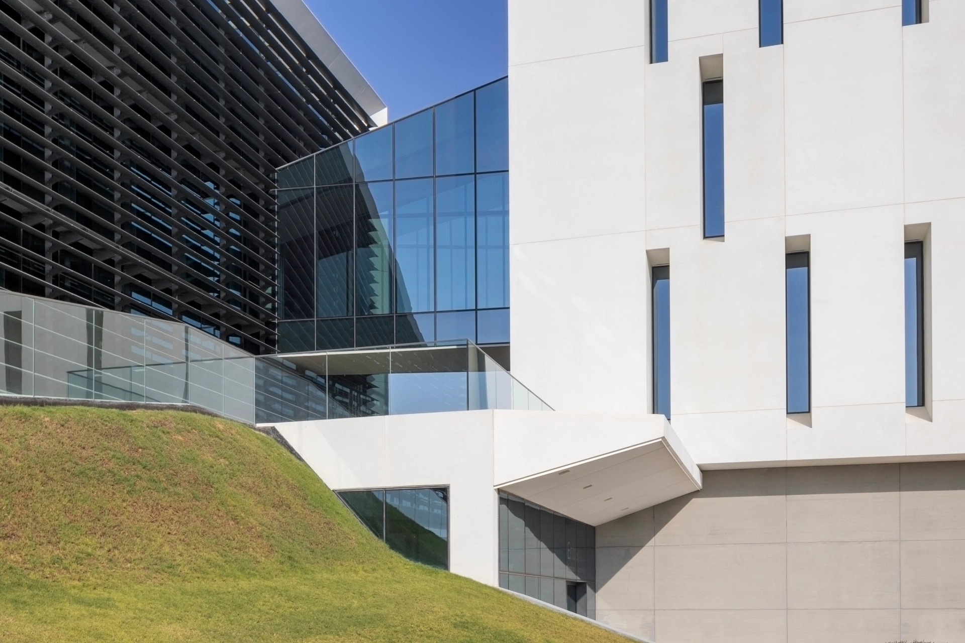 Detail of a contemporary facade with repeating shading fins photographed against clear sky
