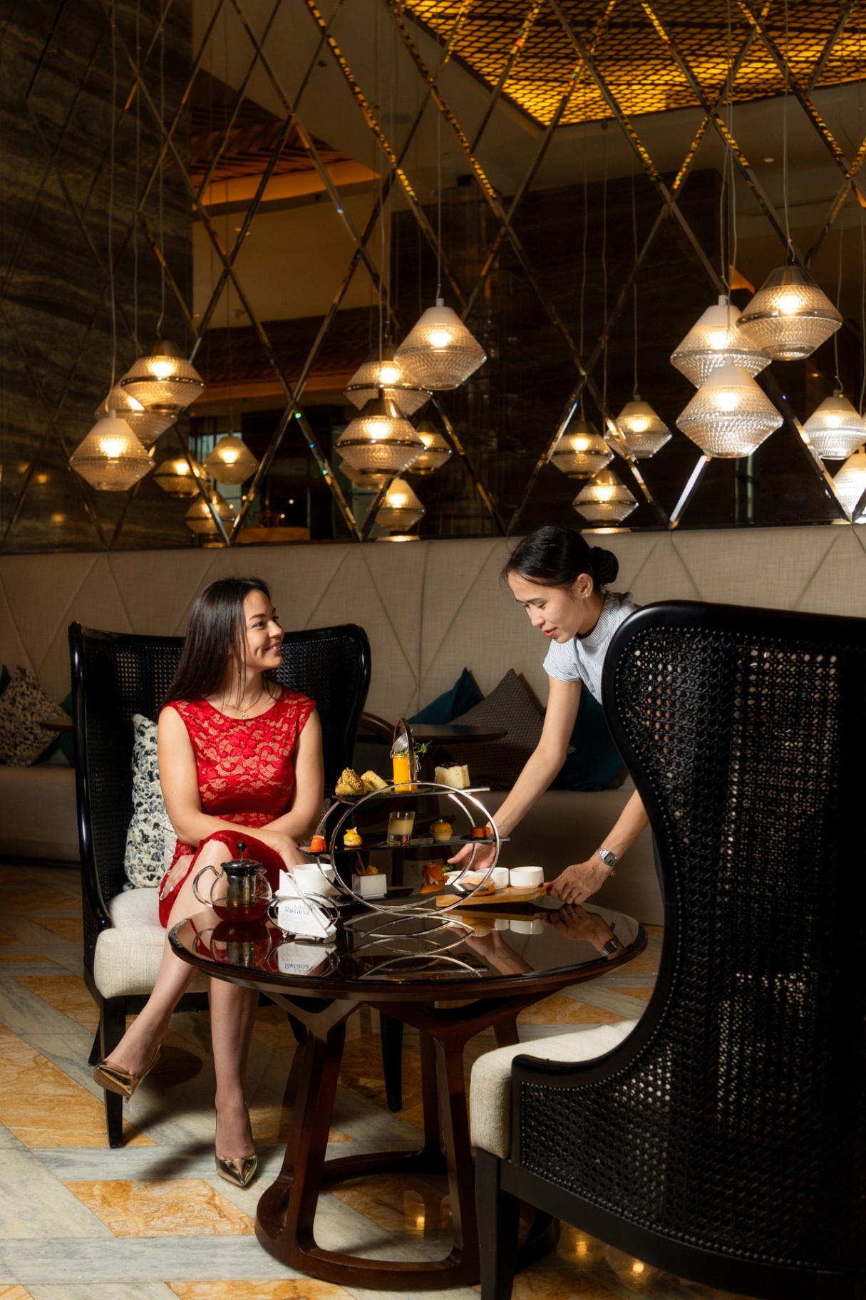 Outdoor resort dining terrace set for evening service under warm lighting