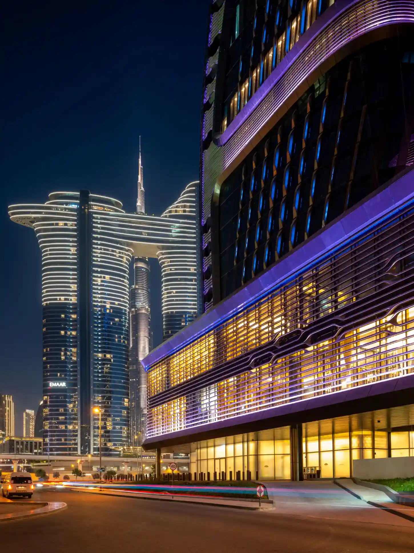 Ceramic-clad tower photographed against open sky with corrected verticals, facade rhythm reading edge to edge